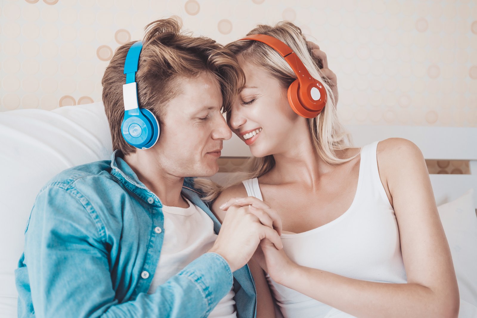 Happy couple listening song in the morning at bedroom